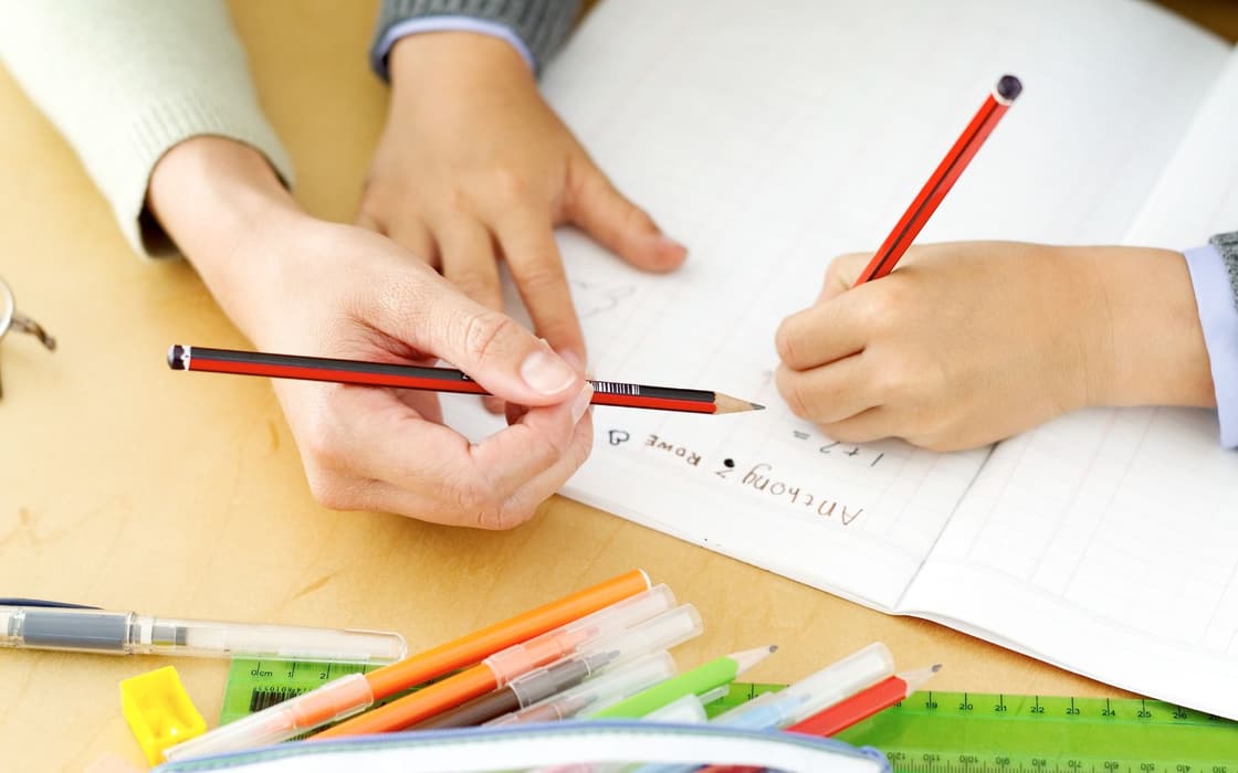 Young student practicing writing with tutor support in Frewsburg, NY