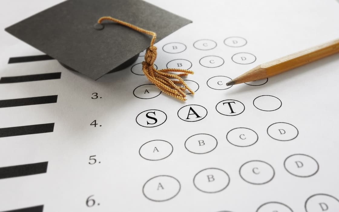 SAT answer sheet with a graduation cap and pencil