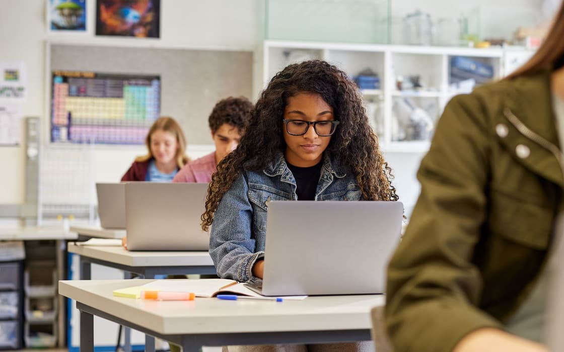 Student working on a laptop in a science classroom