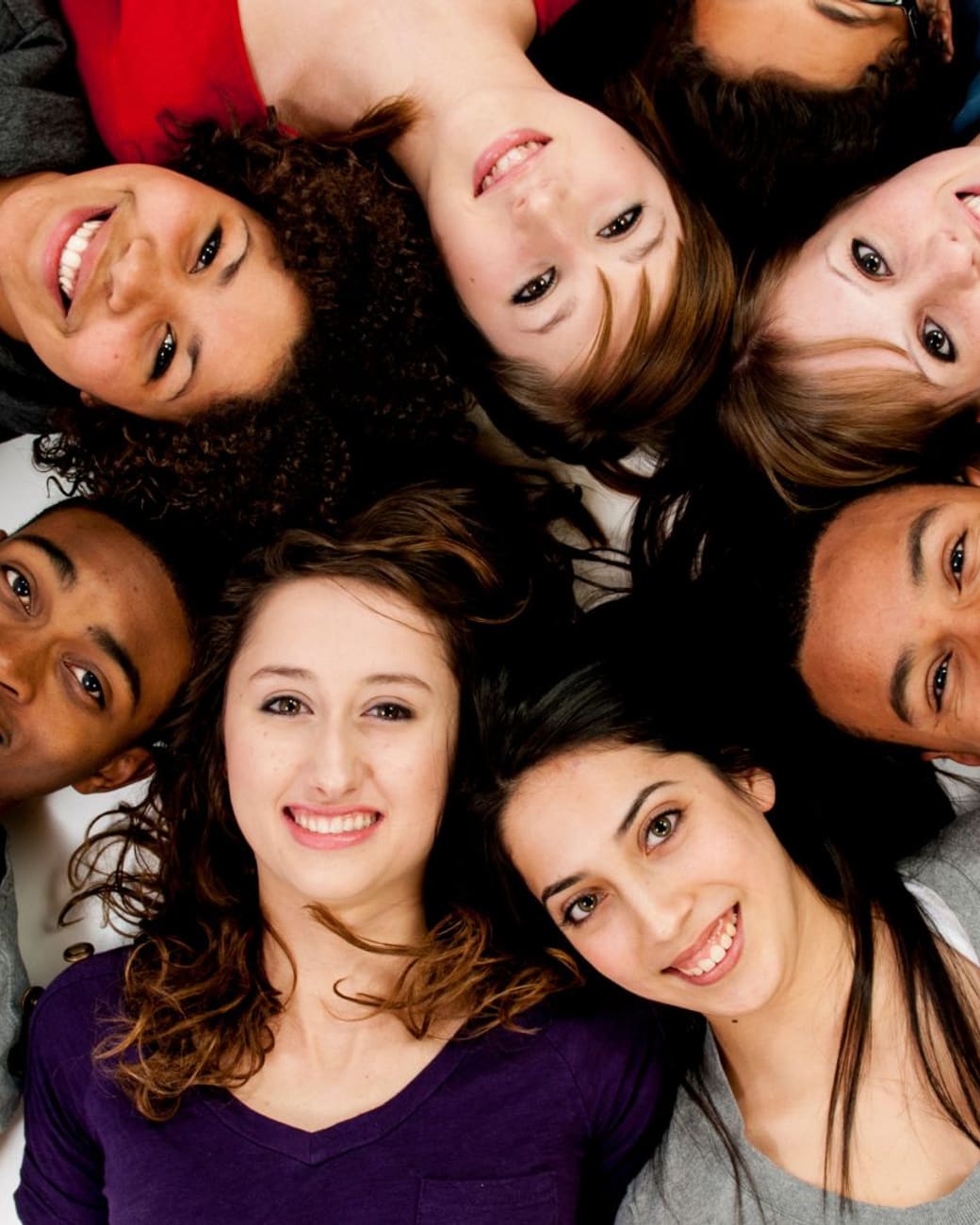 Circle of Dunkirk-area teens laughing together after class
