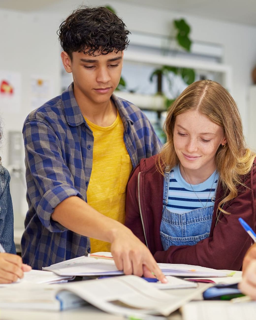 Tutor guiding a study group of Falconer-area teens through a lesson