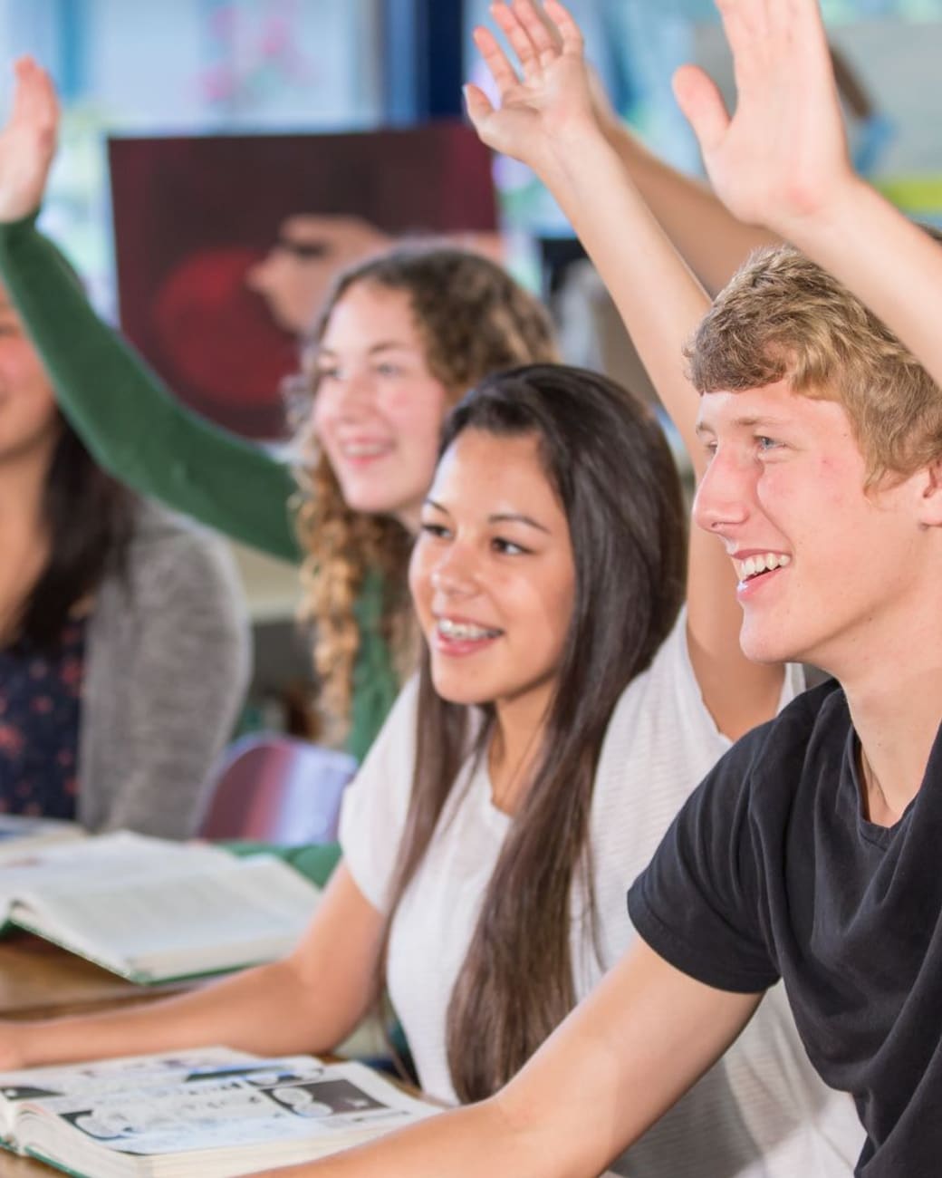 Engaged classroom of students raising hands near Lakewood