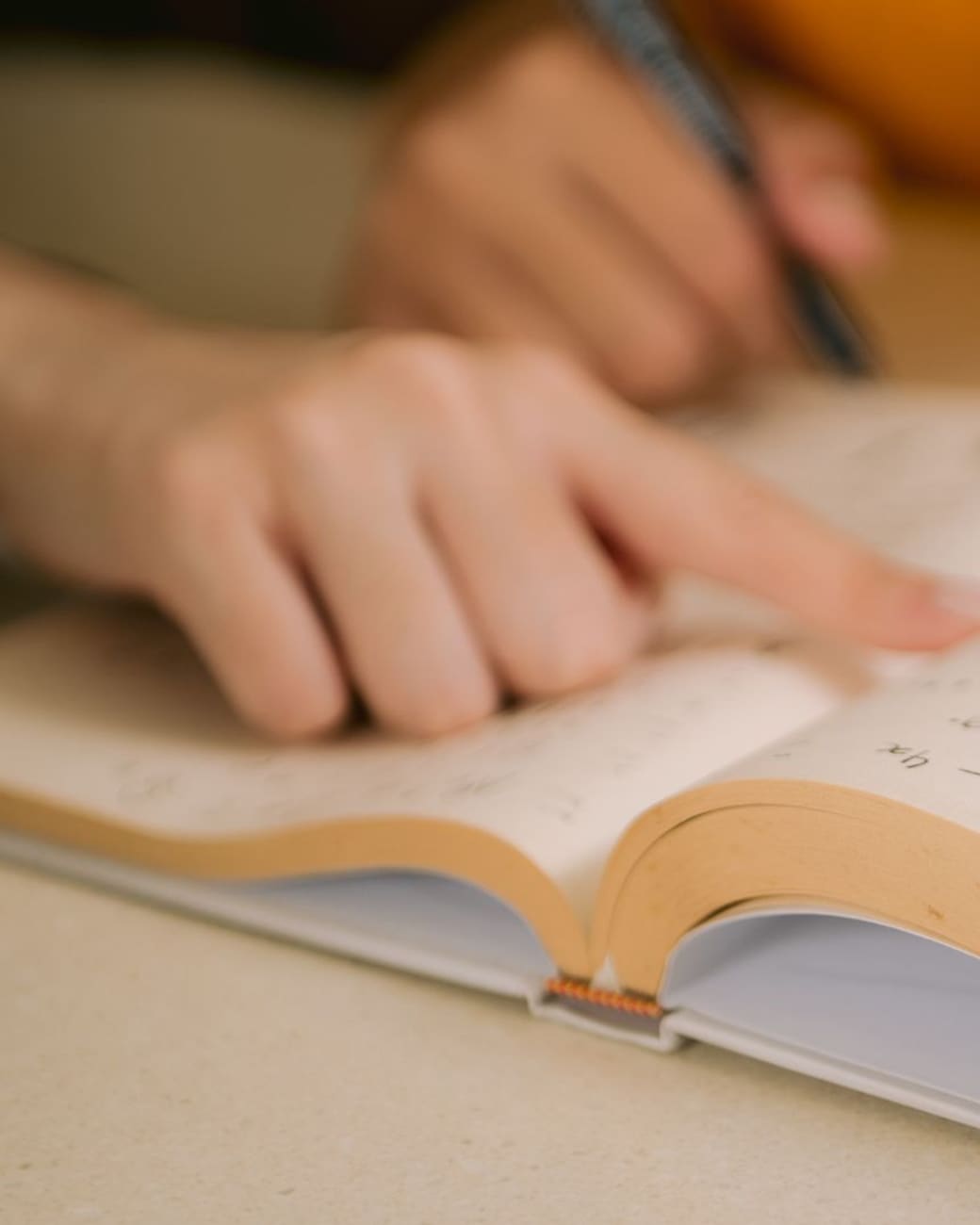 Close-up of a student working math problems by hand