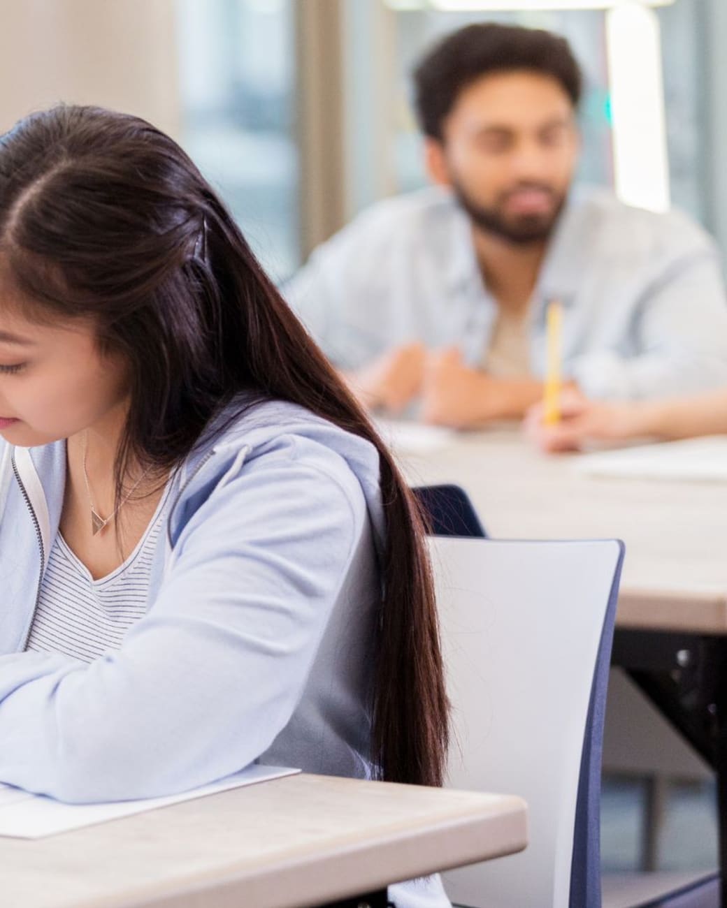 Tutor giving individual feedback on a student's written work