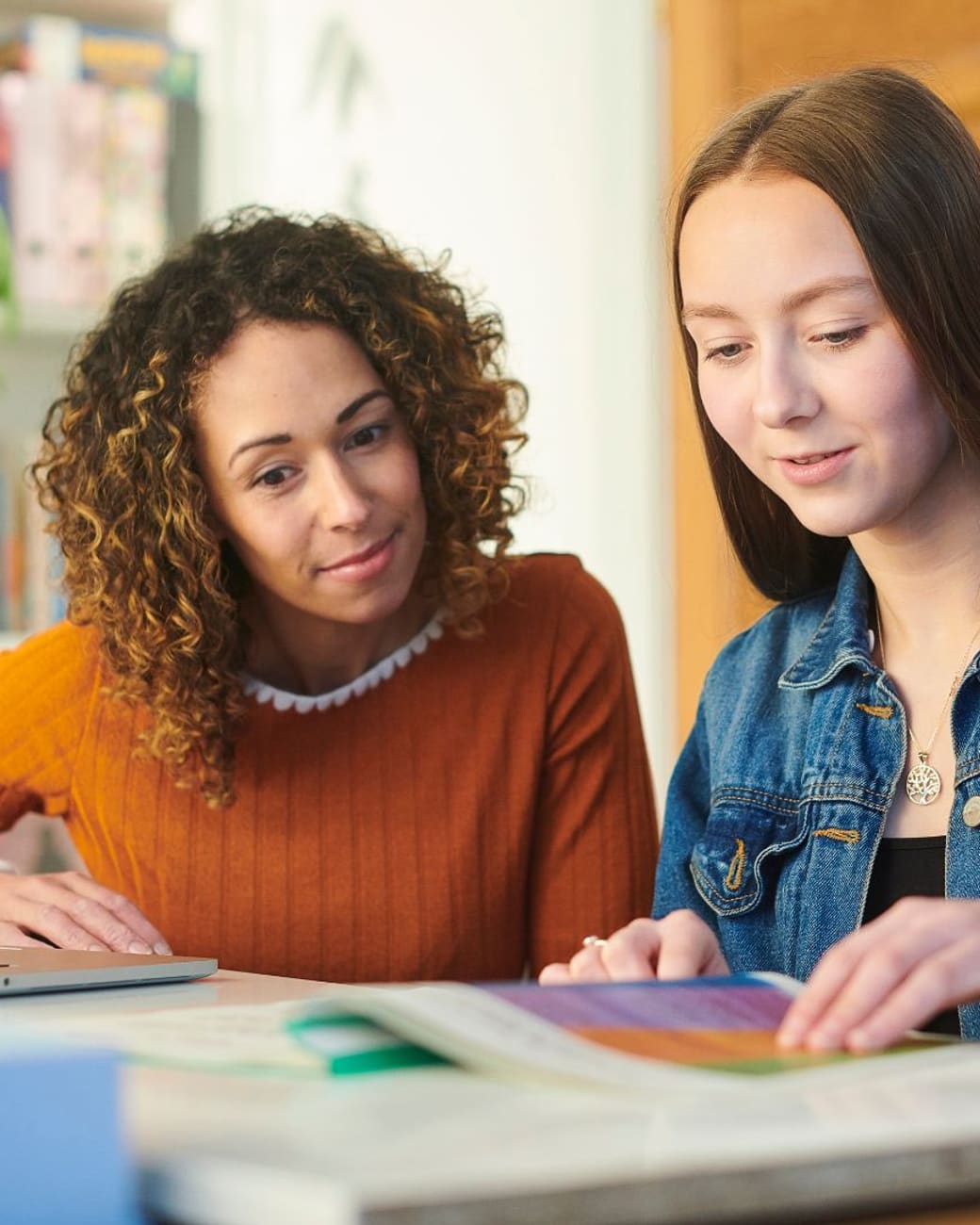 Parent sitting alongside a student during an at-home study session