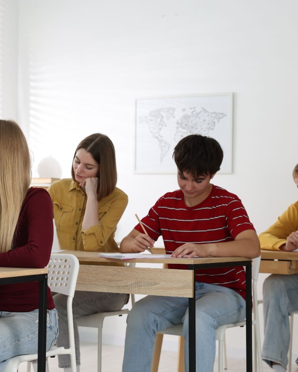 Students writing at desks during a science period